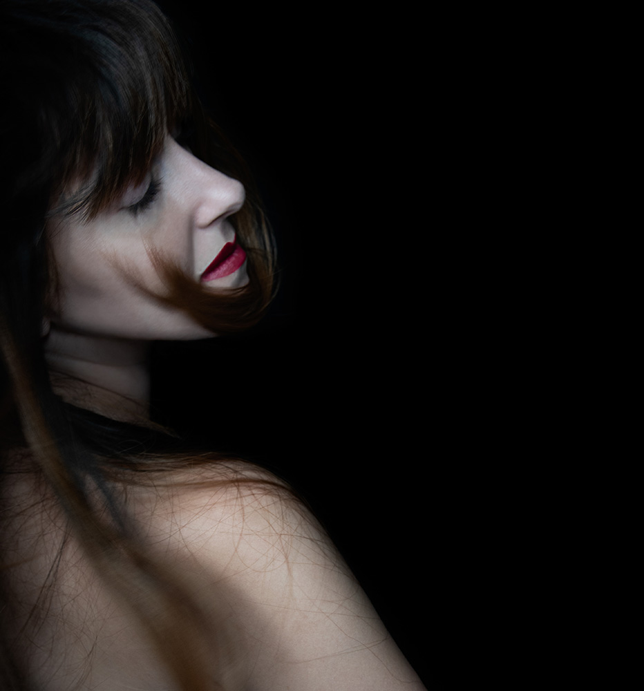 Girl wearing red lipstick and eyes closed throws her long dark hair over her shoulder. Alyssa Bryn Photography. Bryssa. Bryssa Blog.