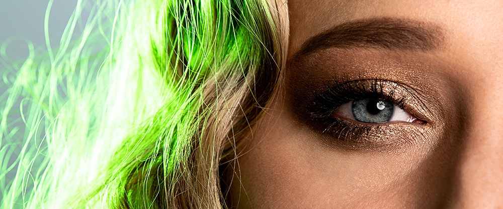 Blue eye girl with heavy gold eyeshadow and blonde hair bathed in green light. Alyssa Bryn Photography. Bryssa. Bryssa Blog.