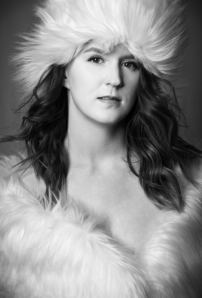 Girl wearing white fur hat and top with hair blowing in black and white photograph. Alyssa Bryn Photography. Bryssa. Bryssa Blog.