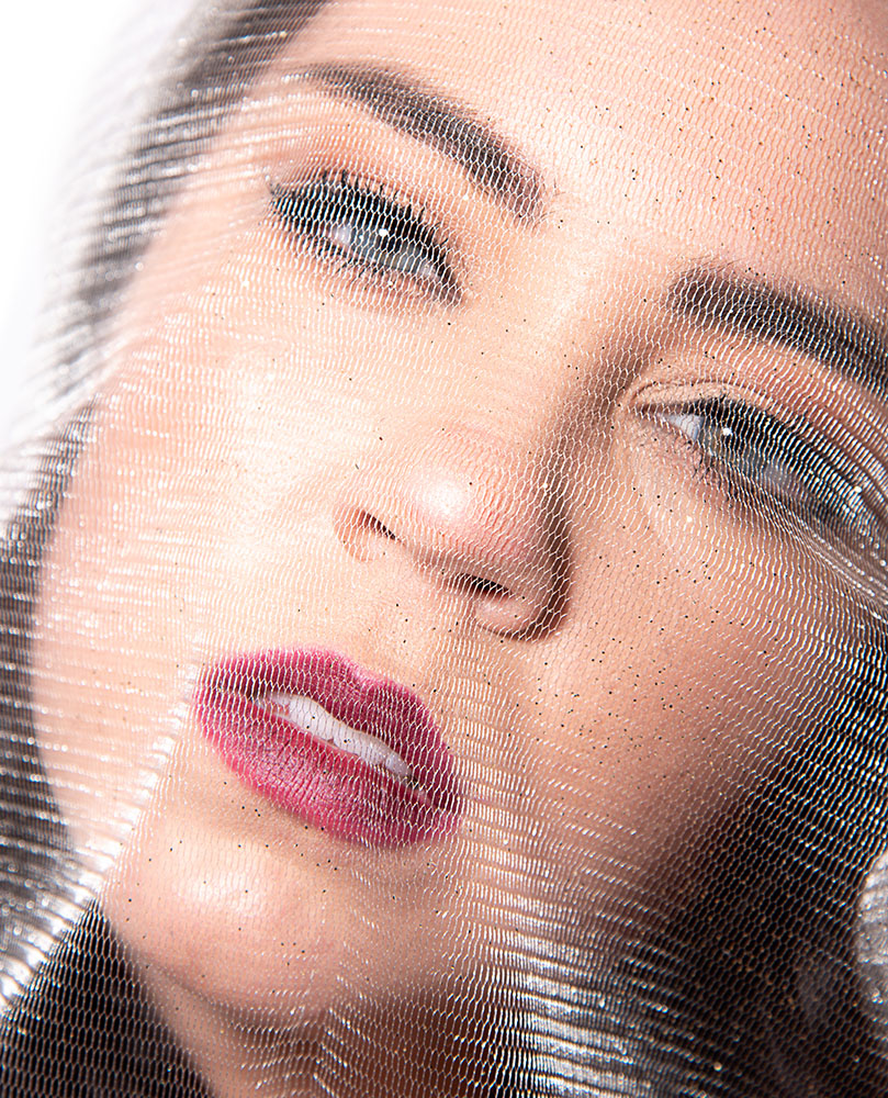 Dark hair blue eye girl screaming with a piece of sheer lace wrapped around her face. Alyssa Bryn Photography. Bryssa. Bryssa Blog.