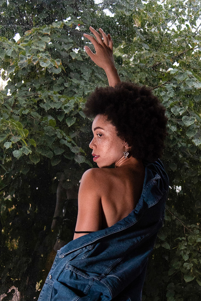 African American girl with beautiful afro stands against a window jean jacket and yellow pants. Alyssa Bryn Photography. Bryssa. Bryssa Blog., 2018. Model Dominique. Photographer Alyssa Bryn Herring. African American girl with beautiful afro stands against a window jean jacket. Alyssa Bryn Photography. Bryssa. Bryssa Blog.