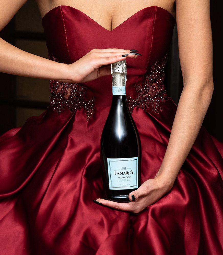 Girl showing off her bottle of La Marca Prosecco wearing beautiful red dress. Alyssa Bryn Photography. Bryssa. Bryssa Blog.
