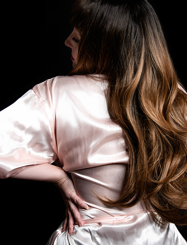 Black view of a girl wearing a pink silk robe with long brown hair down her back. Alyssa Bryn Photography. Bryssa. Bryssa Blog.