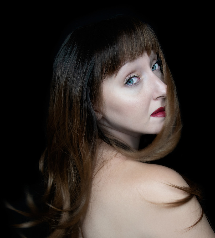 Girl wearing red lipstick and blue eyes throws her long dark hair over her shoulder. Alyssa Bryn Photography. Bryssa. Bryssa Blog.