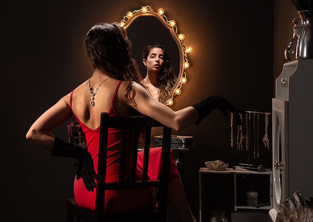 Elegant dark hair girl in red dress and black gloves shows off dramatic backwards diamond neckless. Alyssa Bryn Photography. Bryssa. Bryssa Blog.