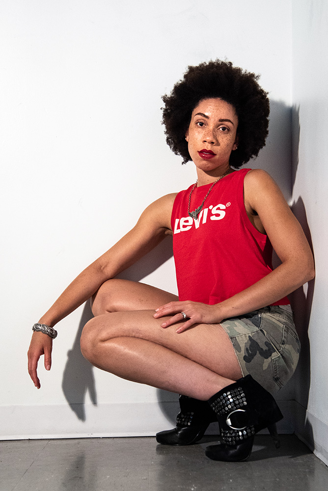 African American girl with beautiful afro wearing red lipstick, black leather jacket and levi red tshirt. Alyssa Bryn Photography. Bryssa. Bryssa Blog.